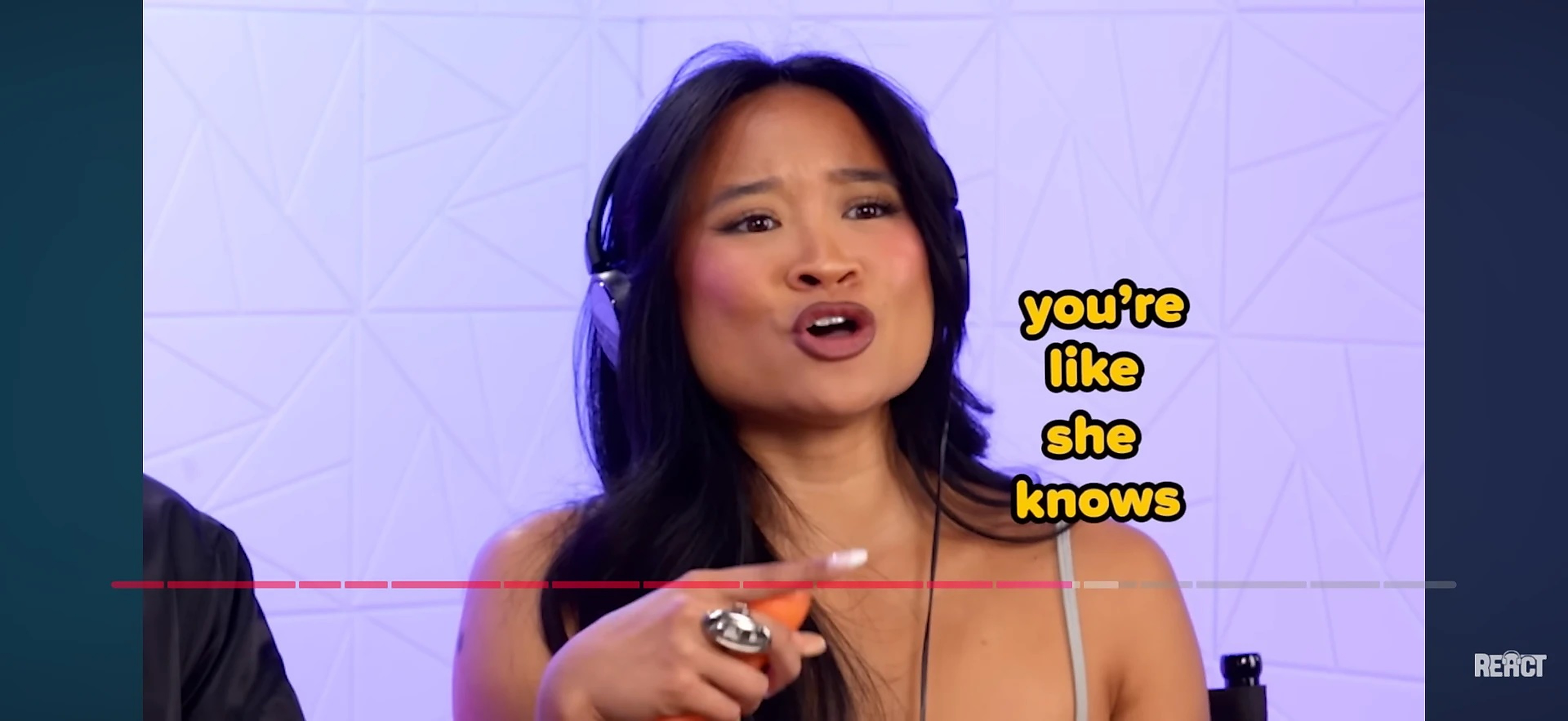Kamryn Hernandez in headphones reacting on camera for REACT